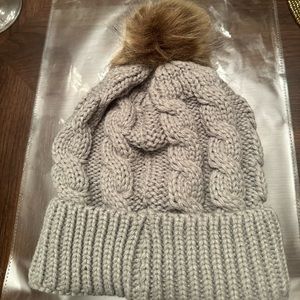 New in packaging. Women’s Grey Soft Puff Beanie. Perfect for the Coldness.